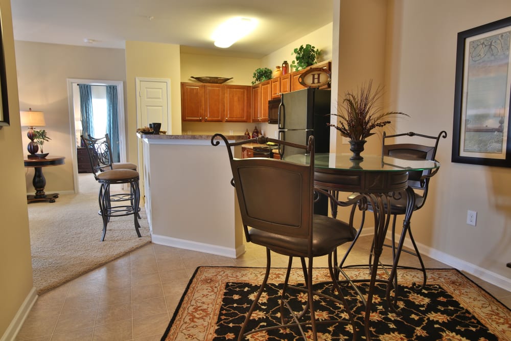 Model dining nook with view of the kitchen at The Heights at McArthur Park in Fayetteville, North Carolina