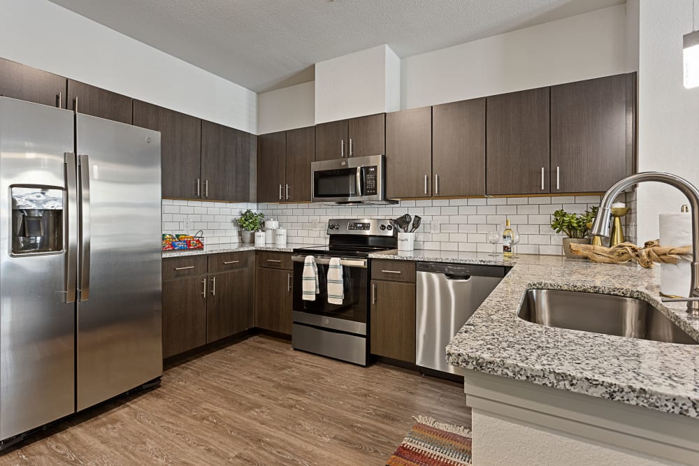 Spacious kitchen with stainless-steel appliances at Olympus Hudson Oaks in Hudson Oaks, Texas