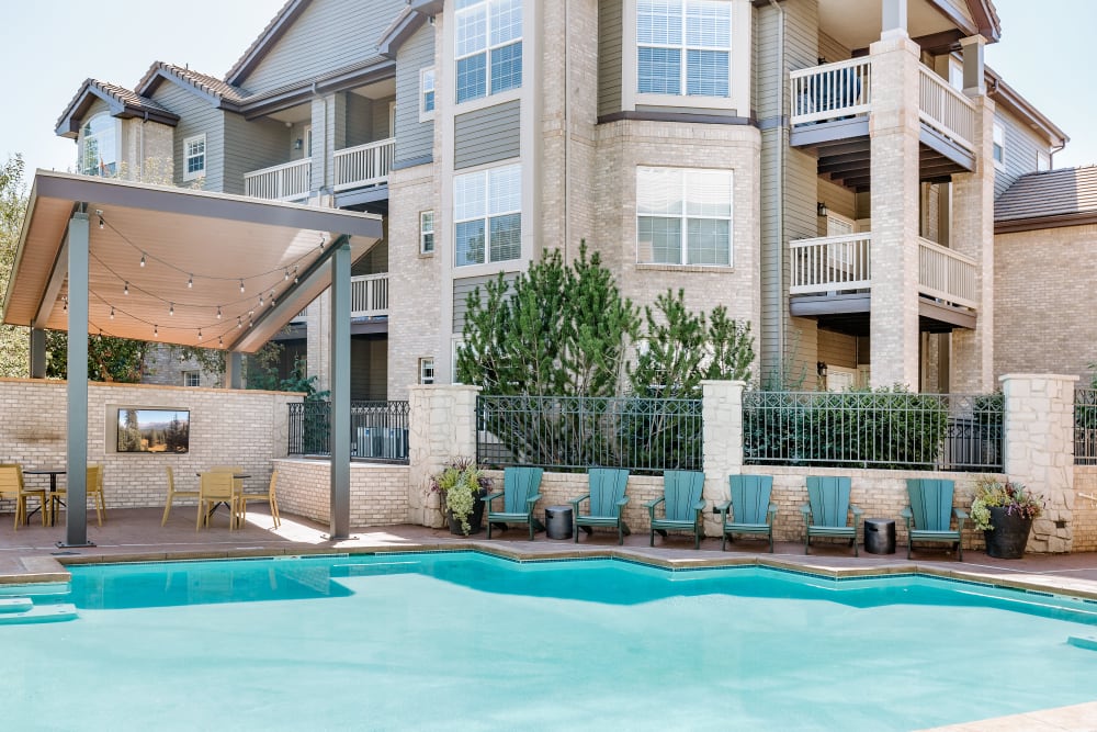 Sparkling pool and outdoor seating at Isabella Apartment Homes in Greenwood Village, Colorado