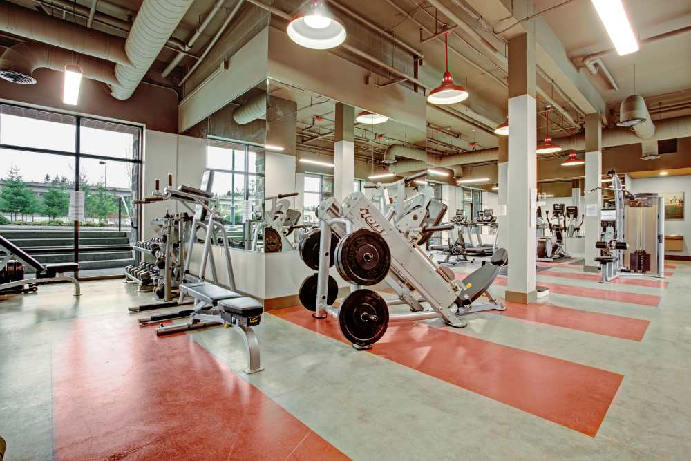 Fitness center with weight machine at Trax at Dupont Station in Dupont, Washington 