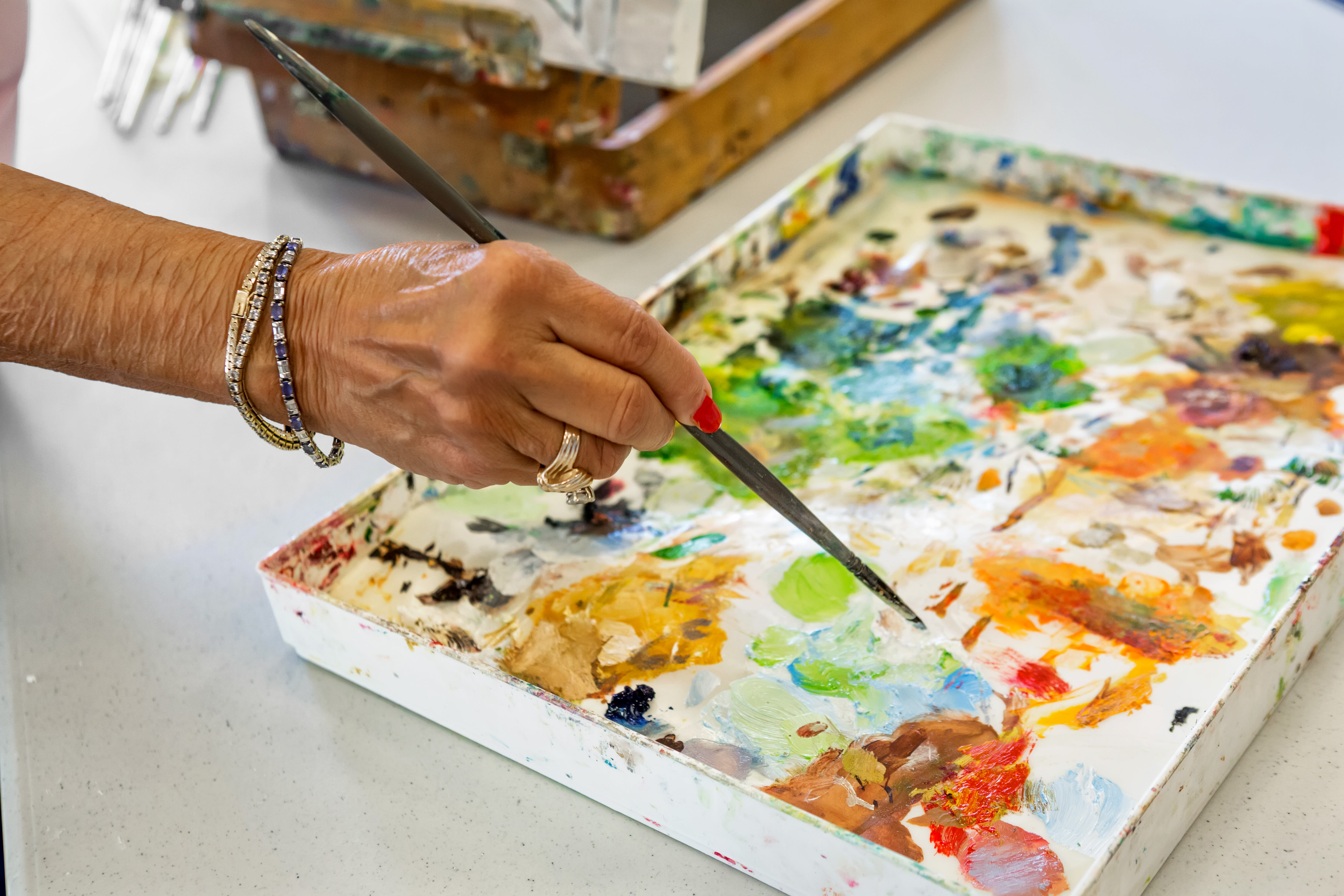 Seniors painting at MuirWoods Memory Care in Petaluma, California
