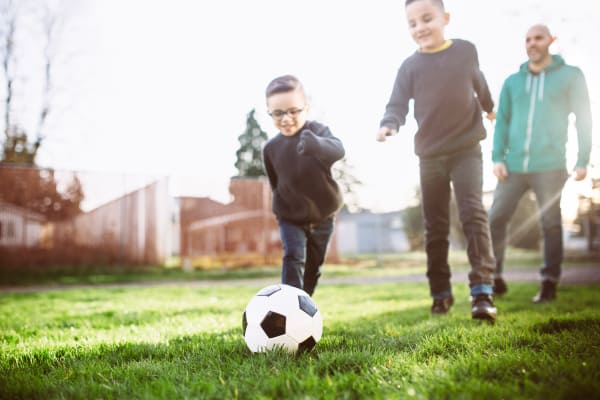 Kids playing football at Maple Trail Apartments & Townhomes in Pasadena, Texas