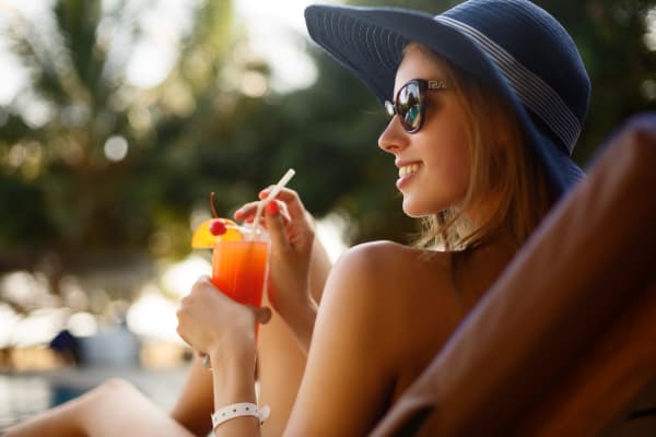 Resident enjoying a drink poolside at Remington Ranch in Litchfield Park, Arizona