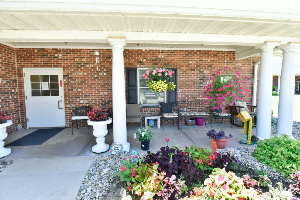 Cheerful porch with foliage at Garden Place Columbia in Columbia, Illinois. 