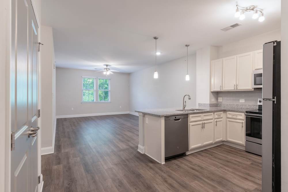 Modern chef-inspired kitchen with wood style flooring at Charthouse at James Island in Charleston, South Carolina