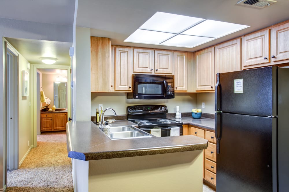 A kitchen and hallway at Royal Farms Apartments in Salt Lake City, Utah