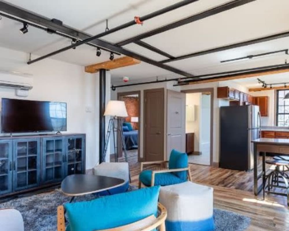Spacious living room with wood style flooring at Lofts at Cargill Falls Mill in Putnam, Connecticut