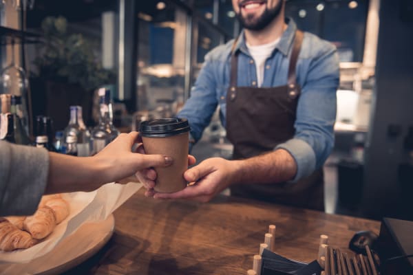 Barista serving coffee near South Meadow in Ames, Iowa.