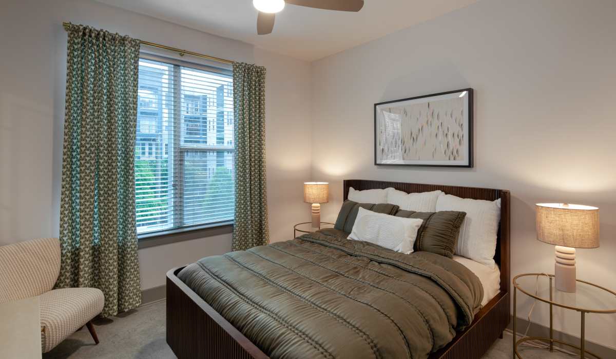 Bedroom with a bright window at Venable Durham Apartments in Durham, North Carolina