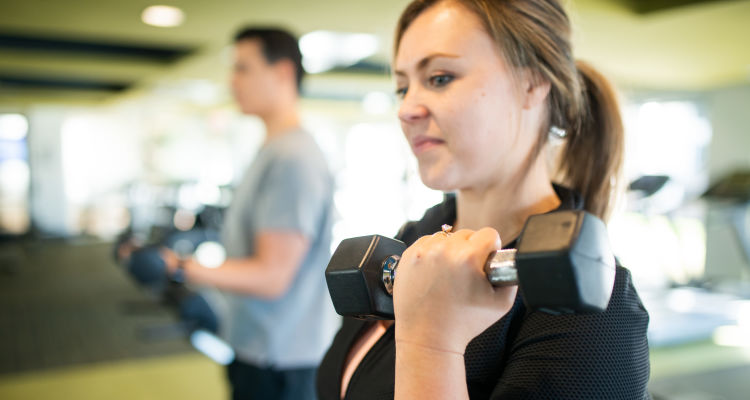 Residents staying in shape in the fitness center at District Lofts in Gilbert, Arizona