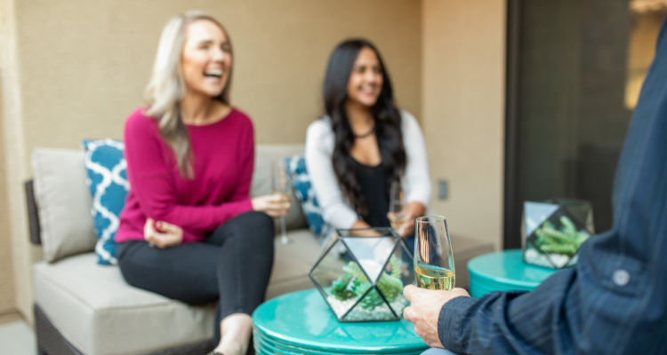 Residents enjoying some champagne on their private patio at Waterside at Ocotillo in Chandler, Arizona