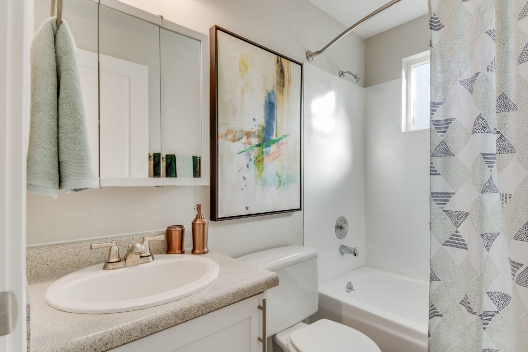 Bathroom featuring a large vanity mirror in an apartment at Copperstone Apartment Homes in Everett, Washington