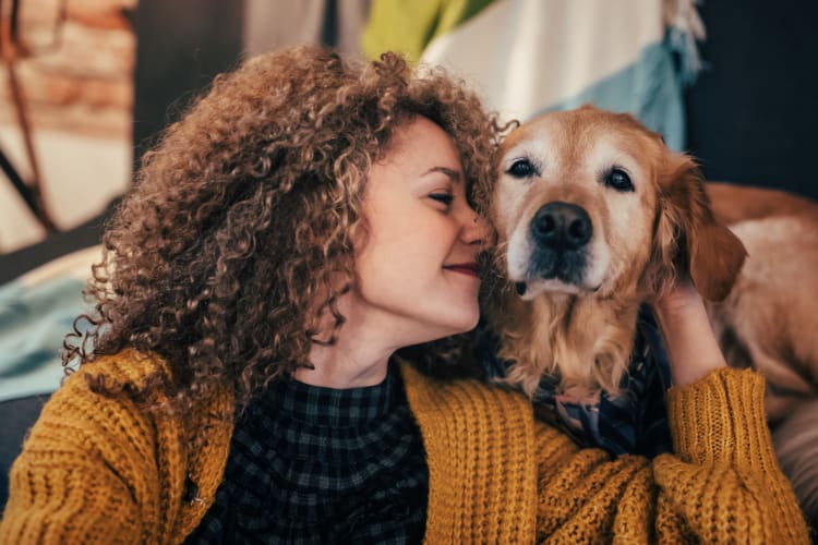 Resident and her dog enjoying their new home at Lumen Apartments in Everett, Washington
