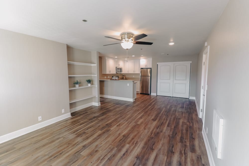 Spacious floor plan with wood flooring and built in shelves at Summerhill Terrace Apartment Homes in San Leandro, California