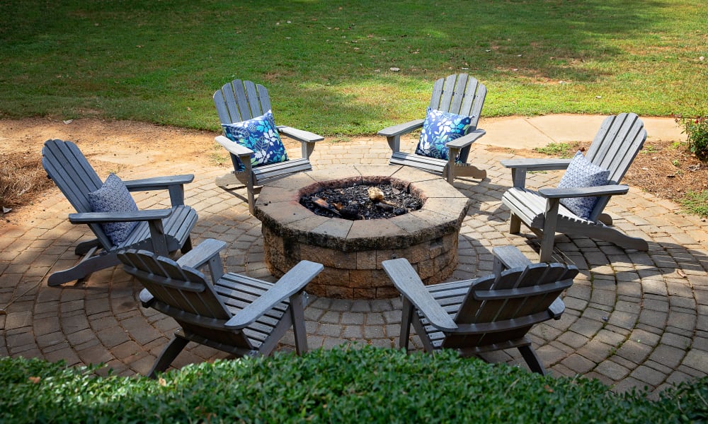 Chairs in a circle around a firepit at Dwell at Carmel in Charlotte, North Carolina