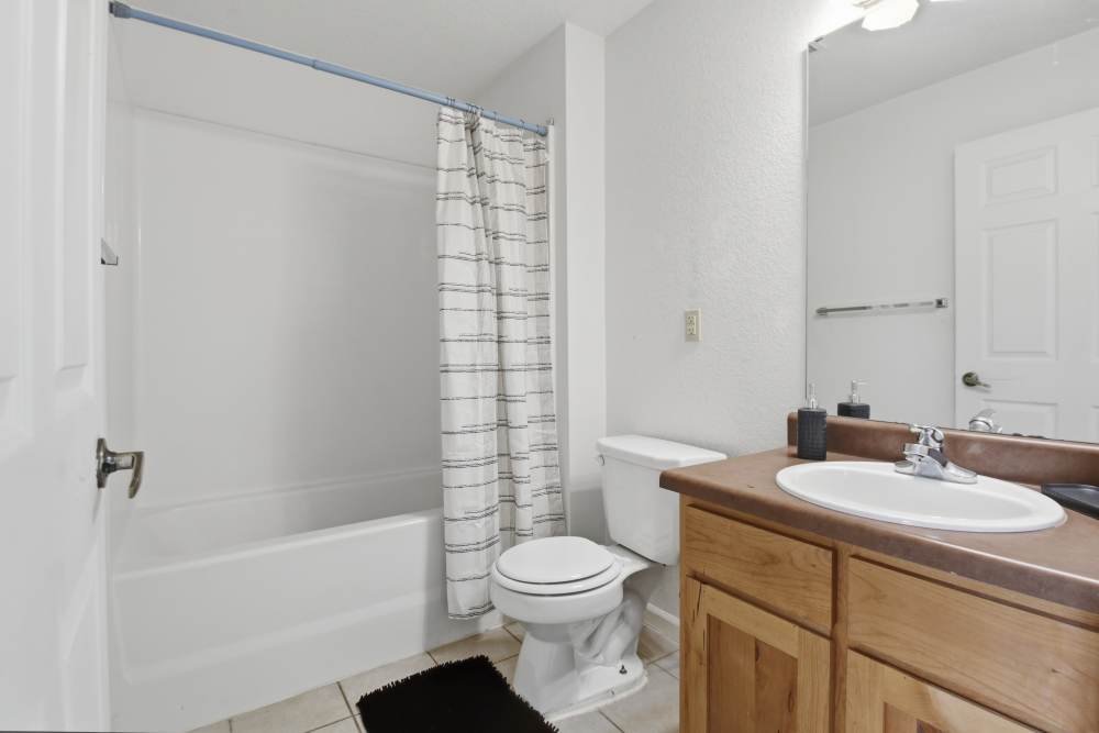 Bright bathtub with bathtub and vanity at Avalon Park in Brownfield, Texas