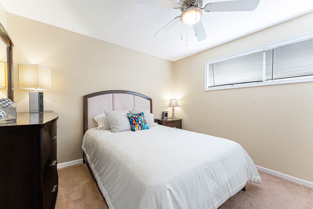 Bedroom with carpet flooring and ceiling fan at Tiger Village in Columbia, Missouri