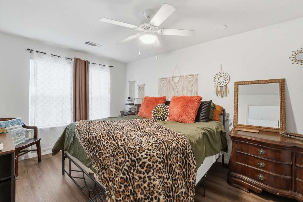Charming bedroom with a stylish mix of decor and natural light at Flats At Sam Lane in Ringgold, Georgia.