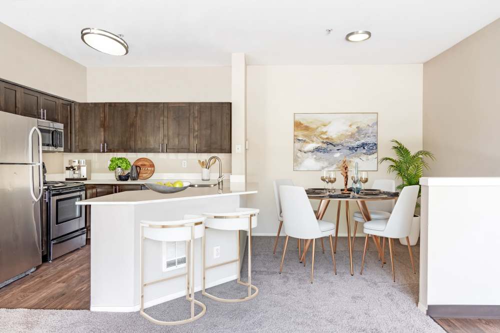Kitchen with stainless-steel appliances and an island at HighGrove Apartments in Everett, Washington