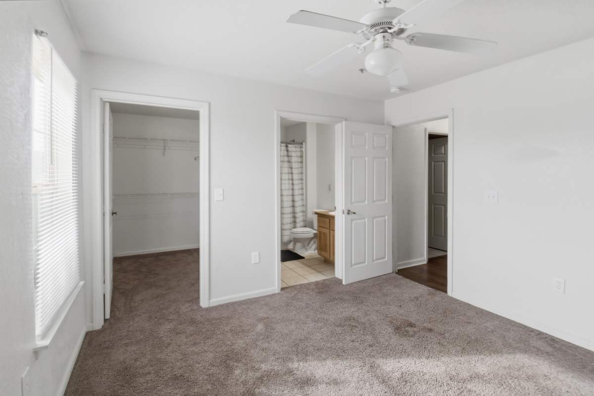 Unfurnished bedroom with attached bathroom at Avalon Park in Brownfield, Texas