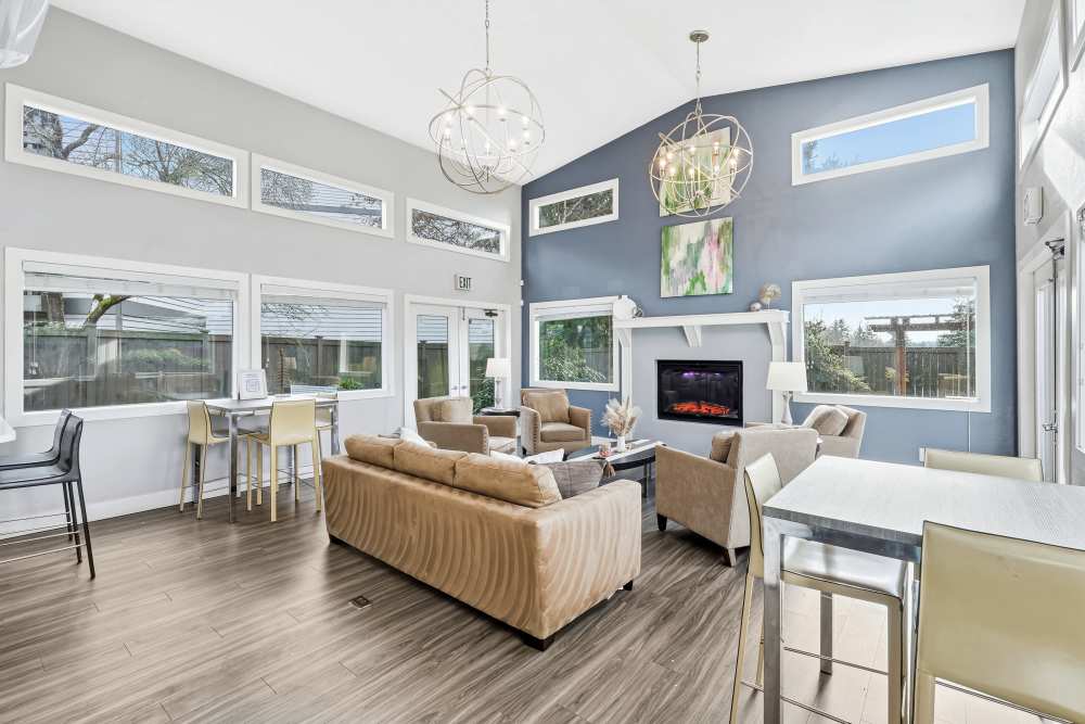 Clubhouse with a fireplace and lounge area at Latitude Apartments in Everett, Washington