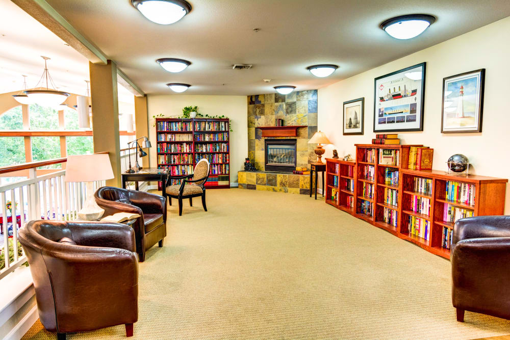 Resident library with comfortable armchairs at Lone Oak Assisted Living in Eugene, Oregon