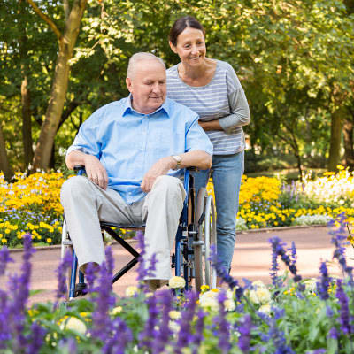 resident enjoying a stroll in the garden at Alderbrook Village in Arkansas City, Kansas