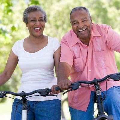 Couple on bike at Orchard View Senior Apartments in Rochester, New York