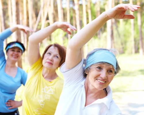 Senior ladies stretching outside at Stonecrest at Burlington Creek in Kansas City, Missouri