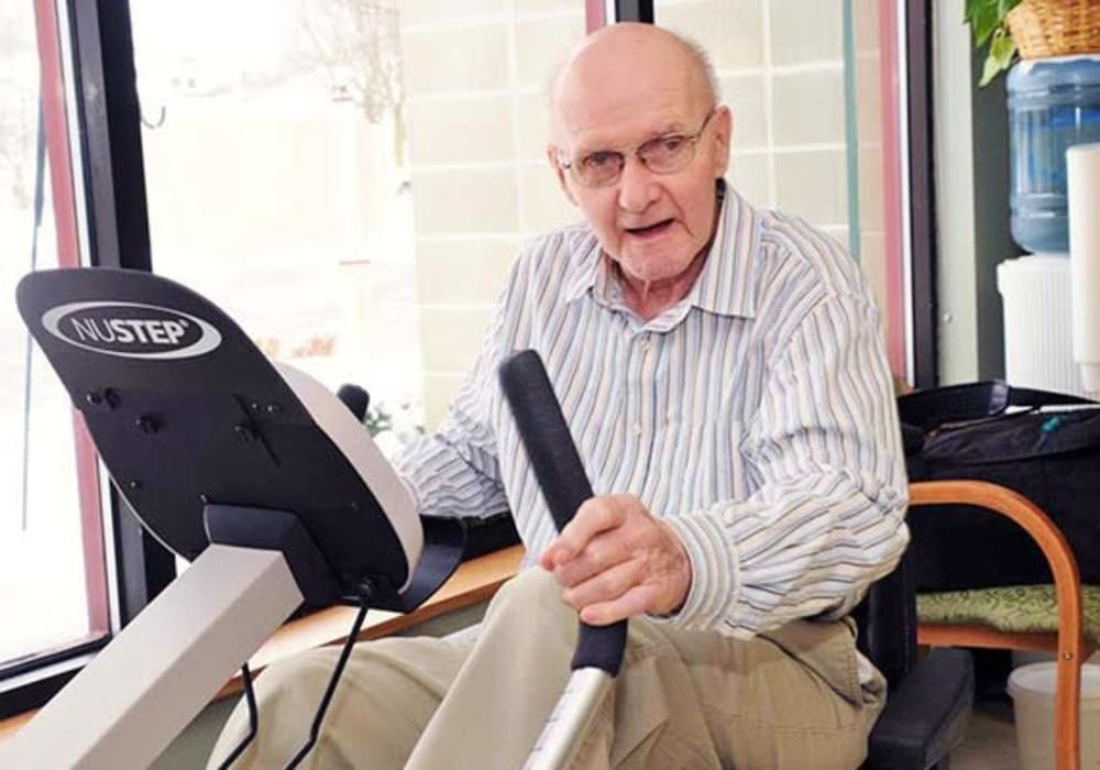 Resident using gym equipment at Holton Manor in Elkhorn, Wisconsin