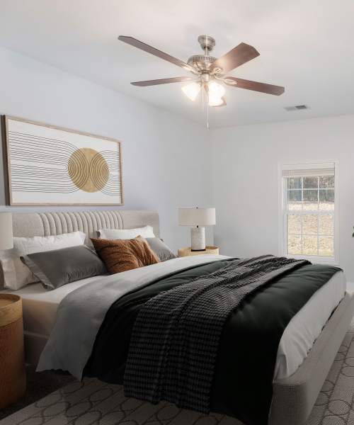Modern bed in a cool room at Crystal Lake & Kingsley Apartments and Townhomes in Fayetteville, North Carolina