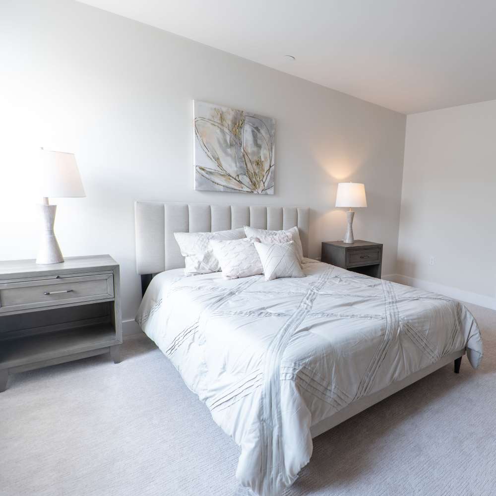 Cozy bedroom with soft lighting at Canandaigua Lake Apartments in Canandaigua, New York