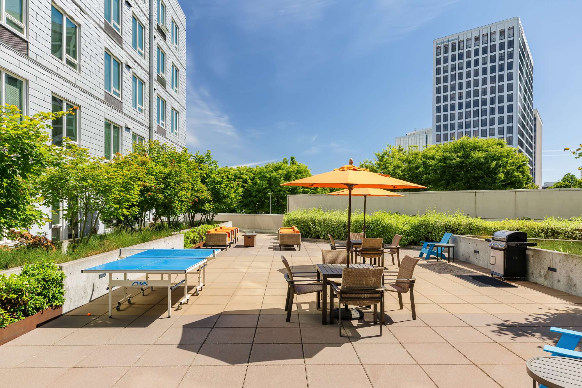 Open courtyard with a ping pong table, chairs and a grill  at The Union in Portland. OR