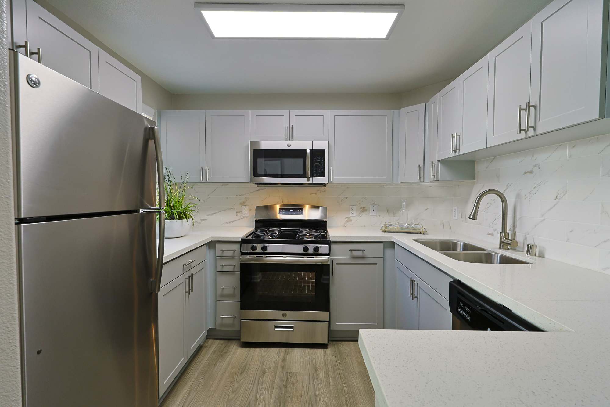 Kitchen with appliances and white cabinets at Allure at Camarillo in Camarillo, California