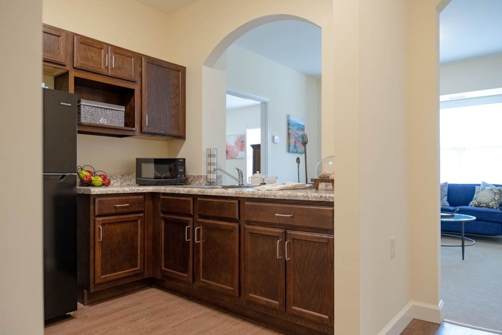 Open layout Kitchen with easy access to living room at The Harmony Collection at Roanoke - Assisted Living in Roanoke, Virginia