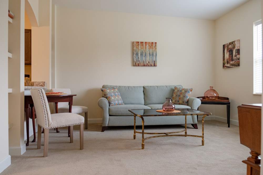 Spacious living room with couch and coffee table at The Harmony Collection at Roanoke - Assisted Living in Roanoke, Virginia