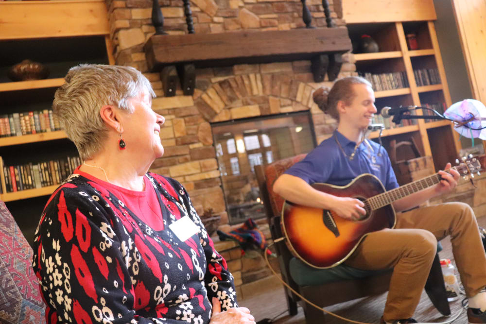 Resident enjoying music provided by caregiver at The Springs at Missoula in Missoula, Montana.