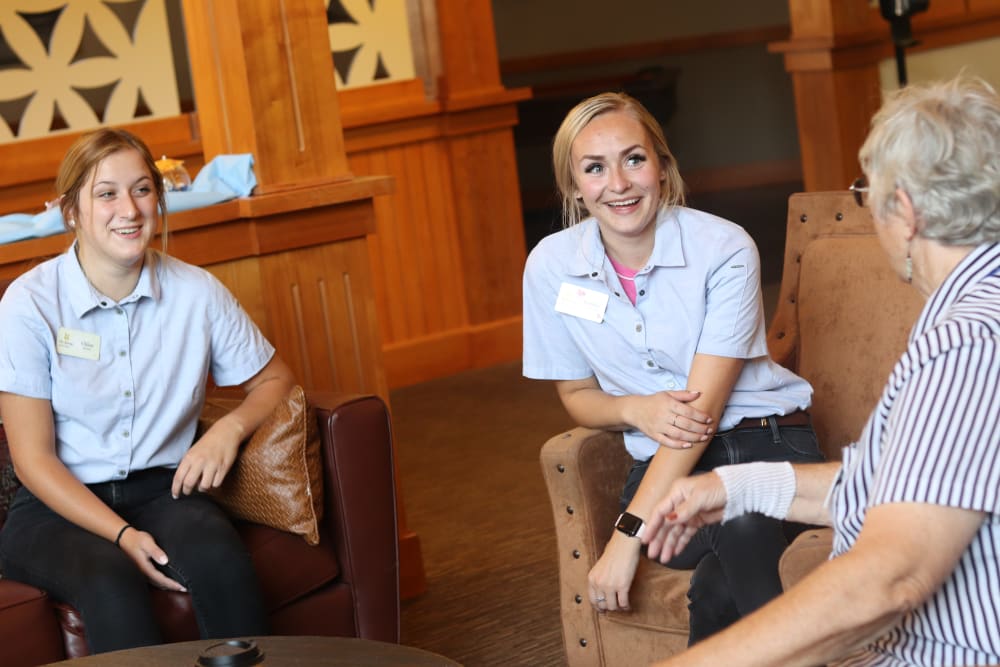 Resident and caregivers chatting in lounge area at The Springs at Missoula in Missoula, Montana.