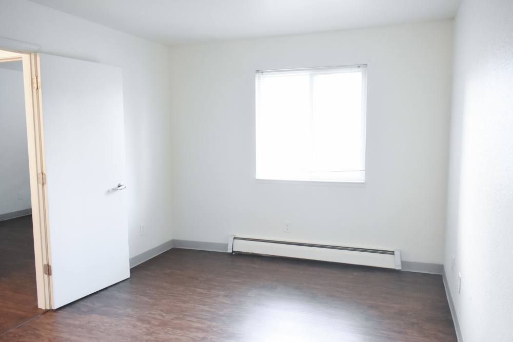 Living room of an apartment with window at Clairewood Apartments in Saint Clair, Michigan