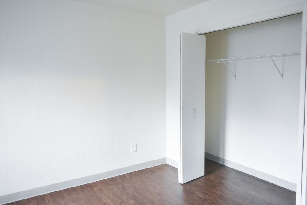 Bedroom with bi-fold door closet at Lakewood Apartments in Stockbridge, Michigan