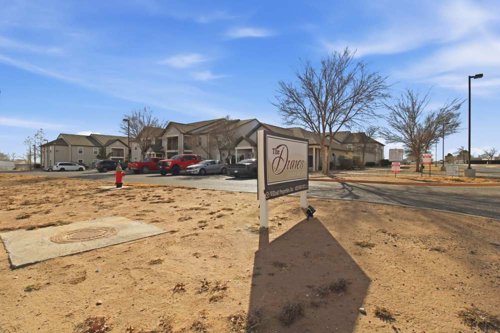 Exterior view of the community with signage board at Dunes Apartments in Seminole, Texas