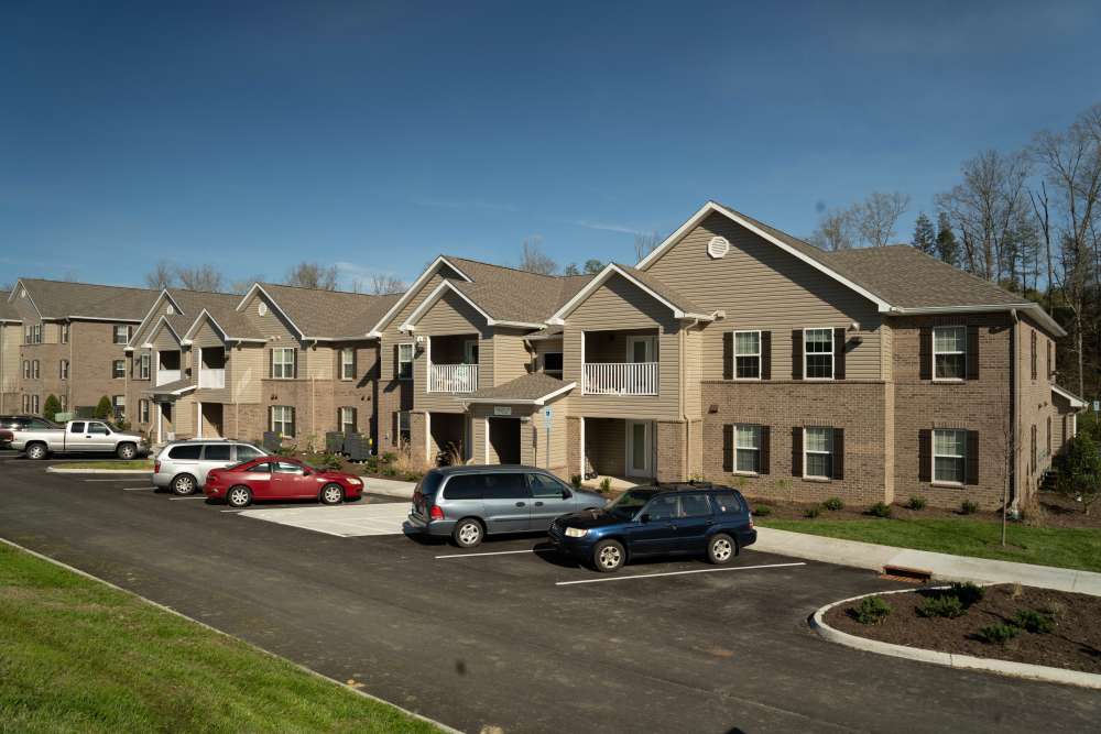 Exterior view of car parking with building at Douglas Greene in Kodak. TN