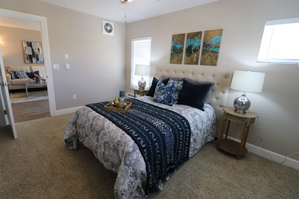 Model bedroom with plush carpeting and natural light at Ramblewood Apartment Homes in Fremont, California