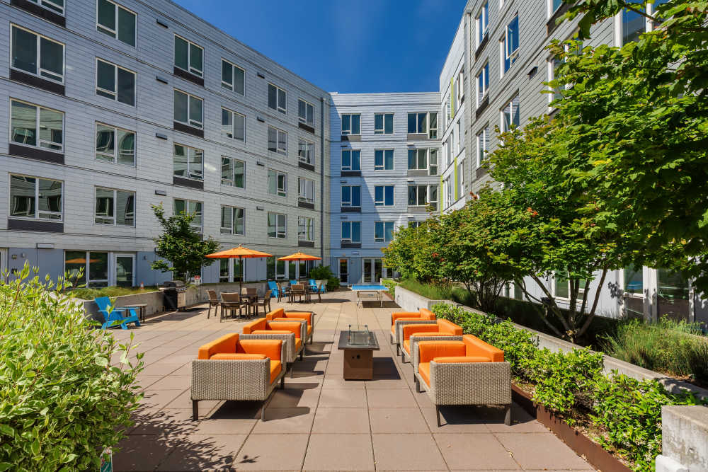 A patio with furniture, trees, multiple seating at The Union in Portland. OR