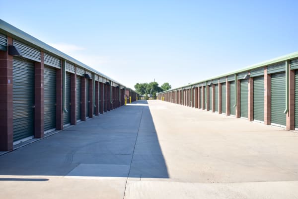 Looking down a wide driveway between exterior storage units at STOR-N-LOCK Self Storage in Fort Collins, Colorado