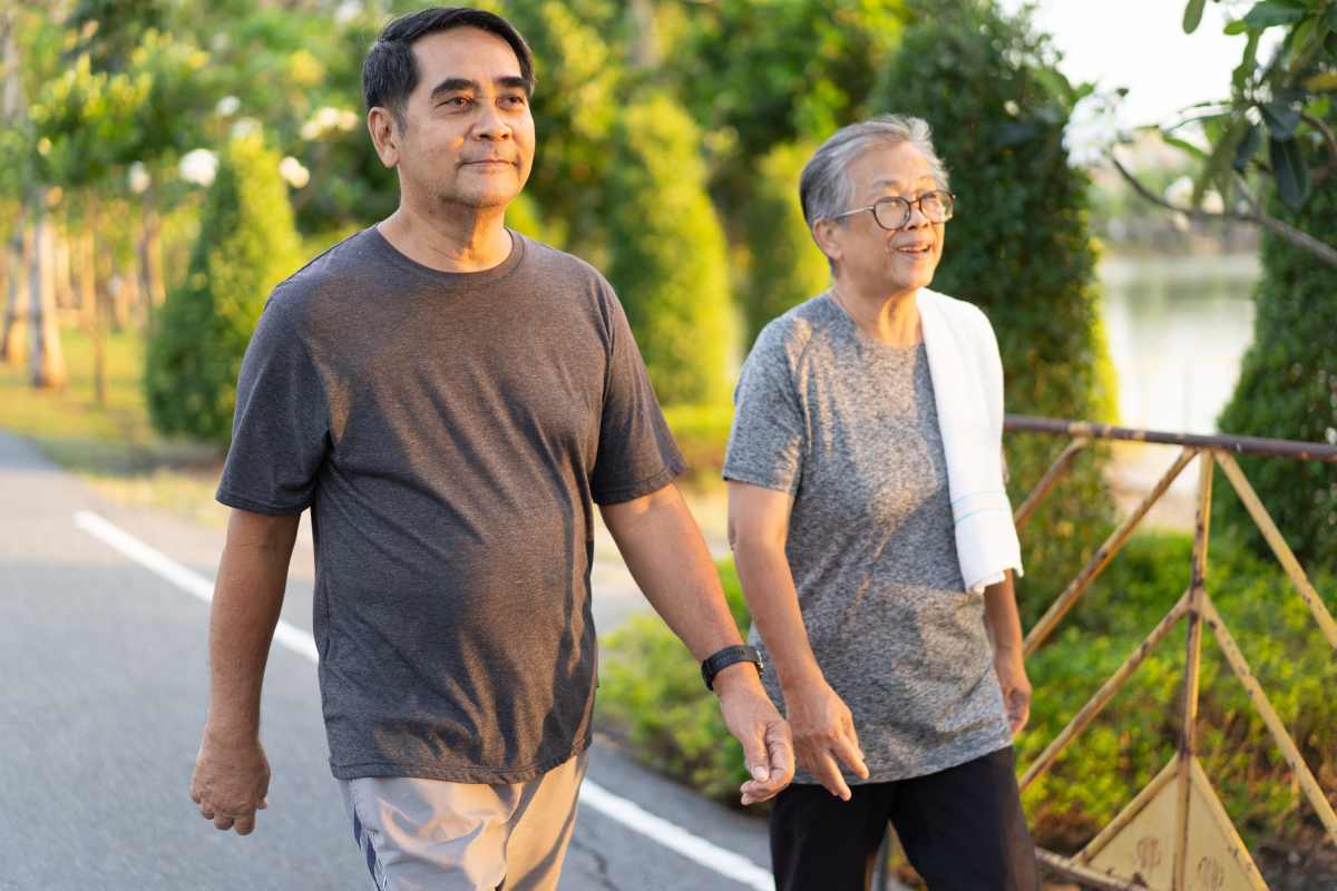 Active adult residents 55+ walking around Reserve Woodland Lakes in Conroe, Tx