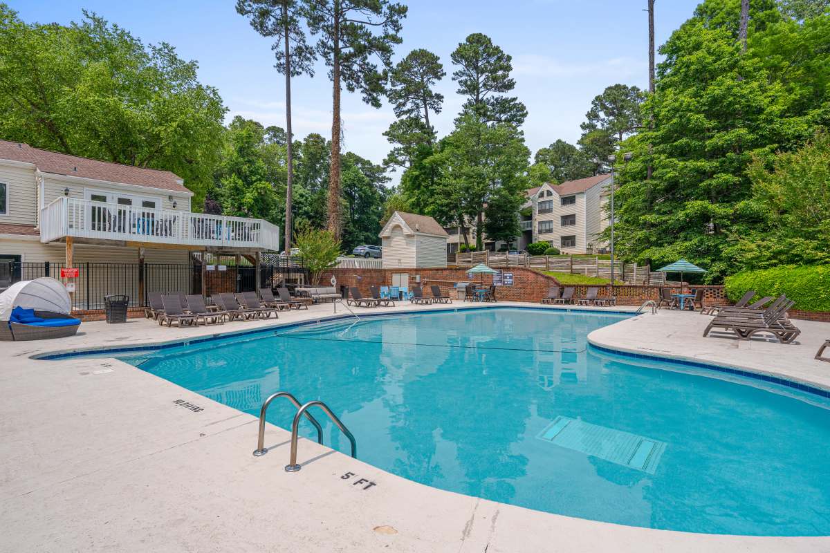 Swimming pool with lounge chairs at Lake Lynn Reserve Apartments, Raleigh, North Carolina