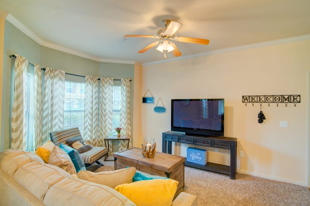 Living room with large windows at Park Hudson Place in Bryan, Texas
