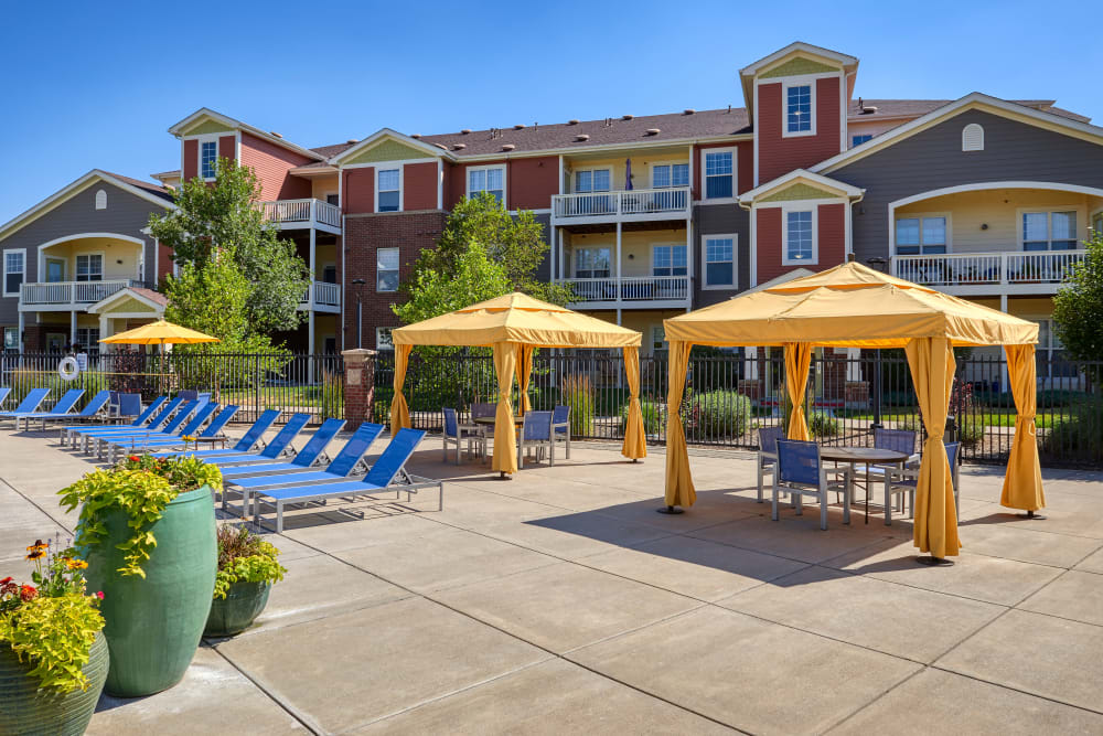Beautiful resort-style cabanas and lounge chairs by the swimming pool at Bear Valley Park in Denver, Colorado