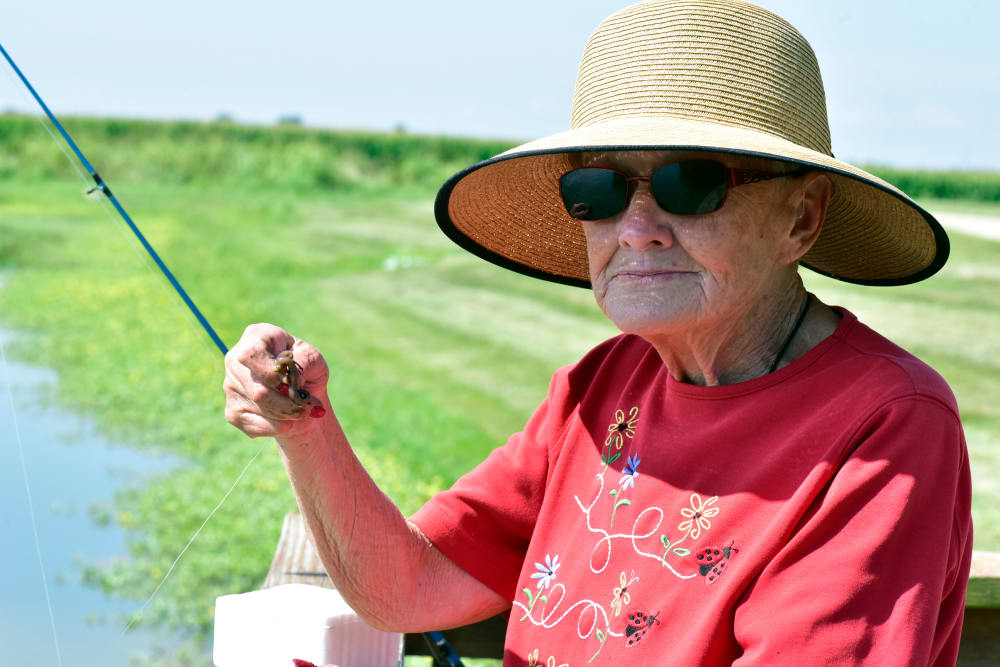 A resident fishing on a sunny day at Garden Place Columbia in Columbia, Illinois. 